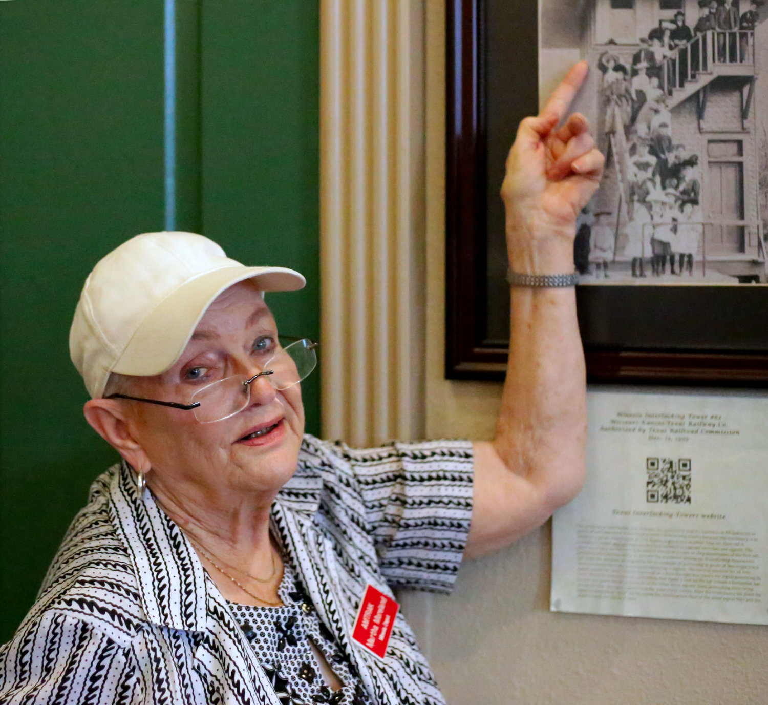 Station host Martha Moreland points out her grandfather, James Ross Cowen, in a photograph at the Interlocking Tower.
